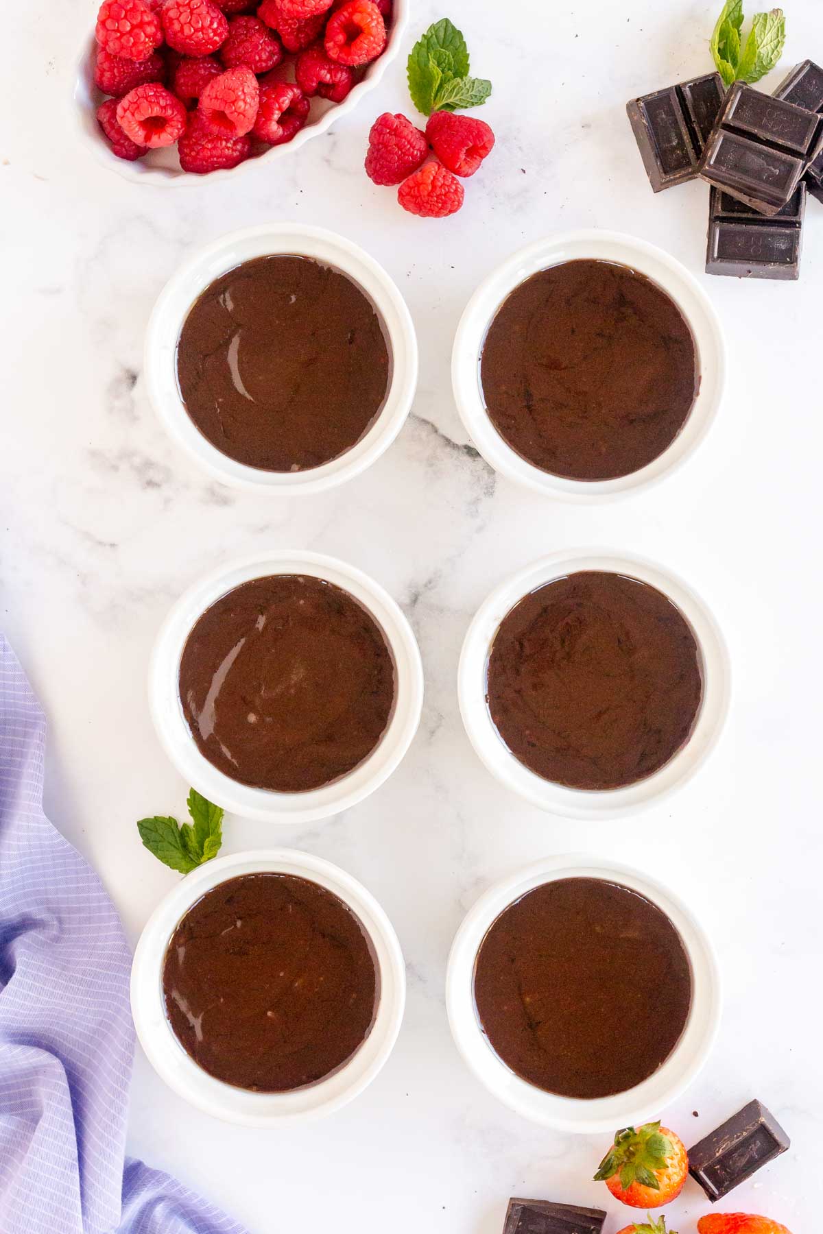 Six ramekins with chocolate lava cake batter