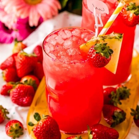 Strawberry cotton candy drink surrounded by flowers and fruit