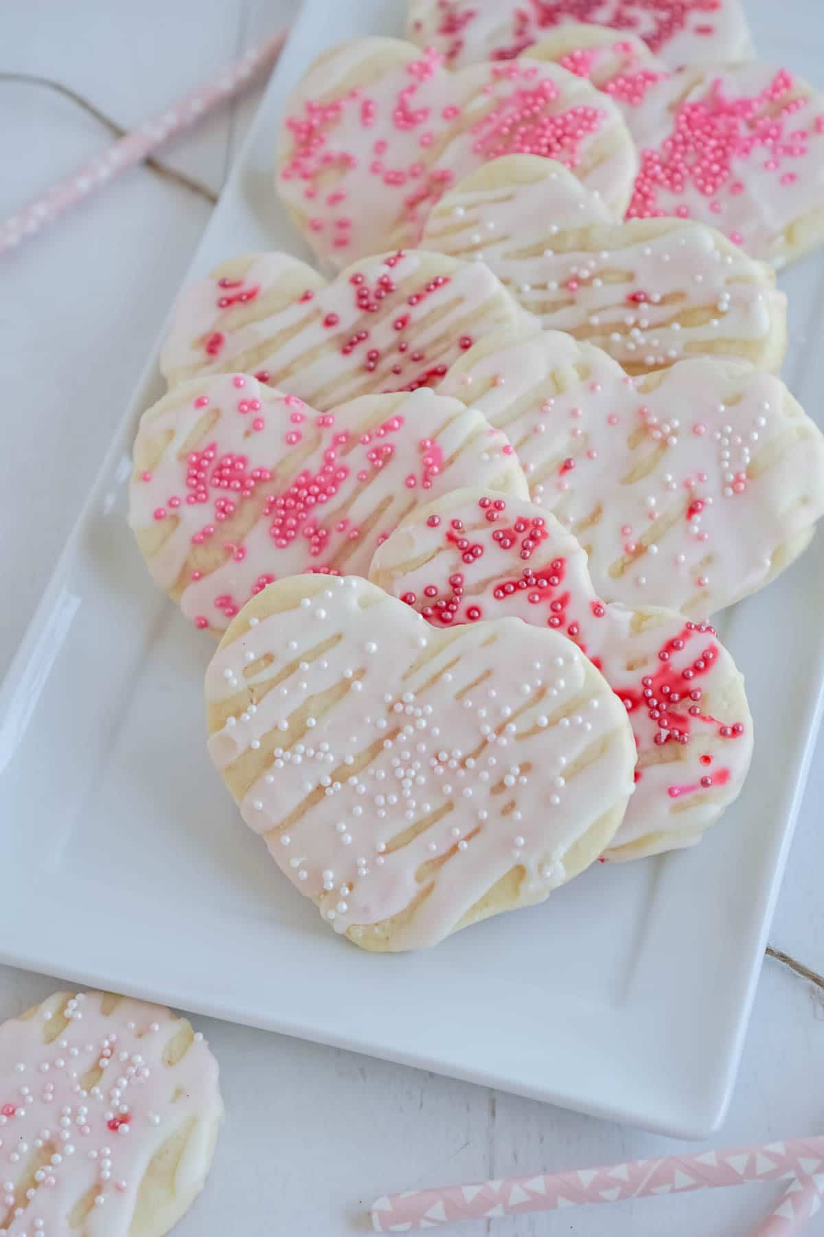 White plate with cream cheese sugar cookies