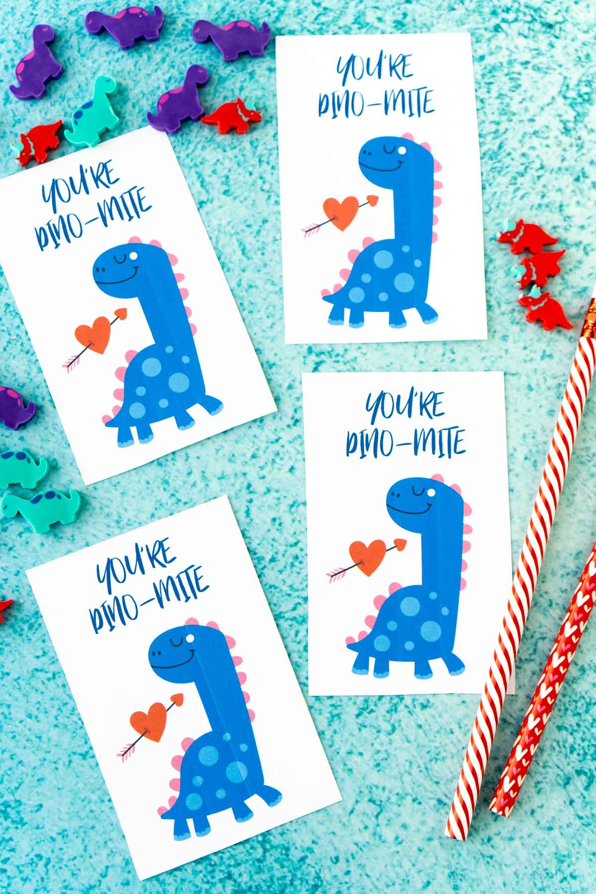 Four dinosaur valentines on a blue background