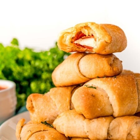 Stack of pizza roll ups on a blue plate