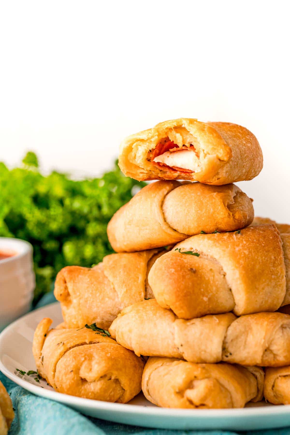 Stack of pizza roll ups on a blue plate
