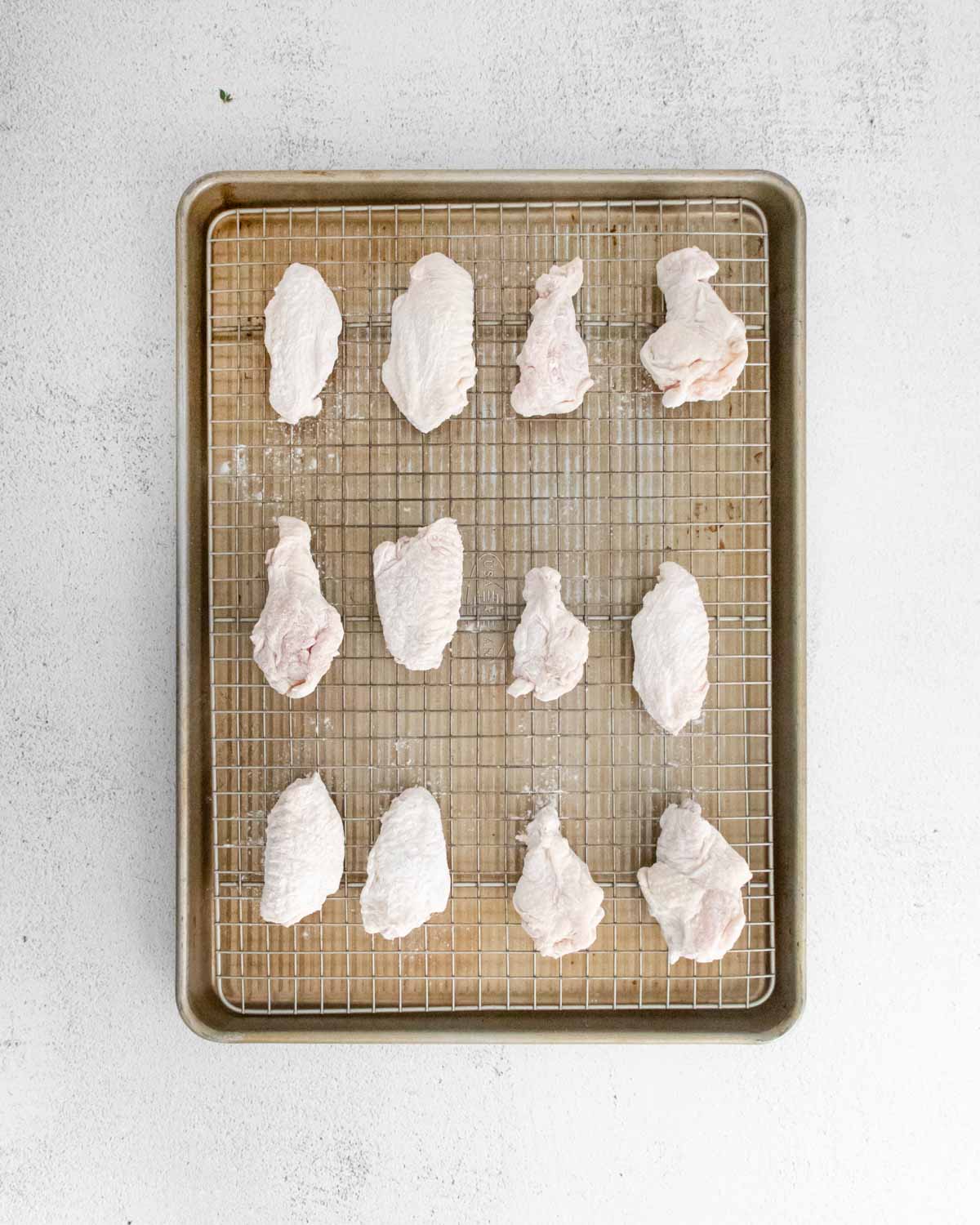 unbaked wings on a baking sheet