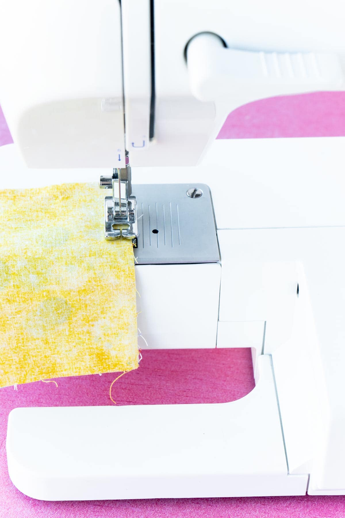 Sewing machine with two pieces of yellow fabric