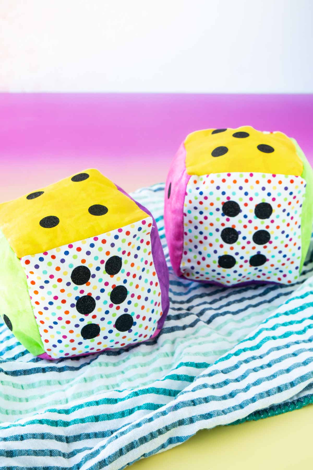 Two colorful DIY dice made out of fabric