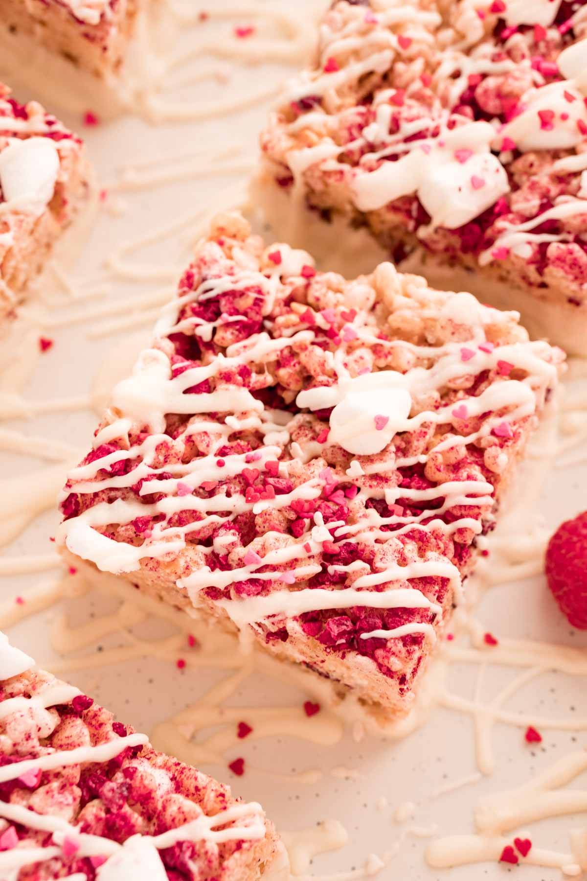 Chocolate dipped rice krispie treat with white chocolate on top