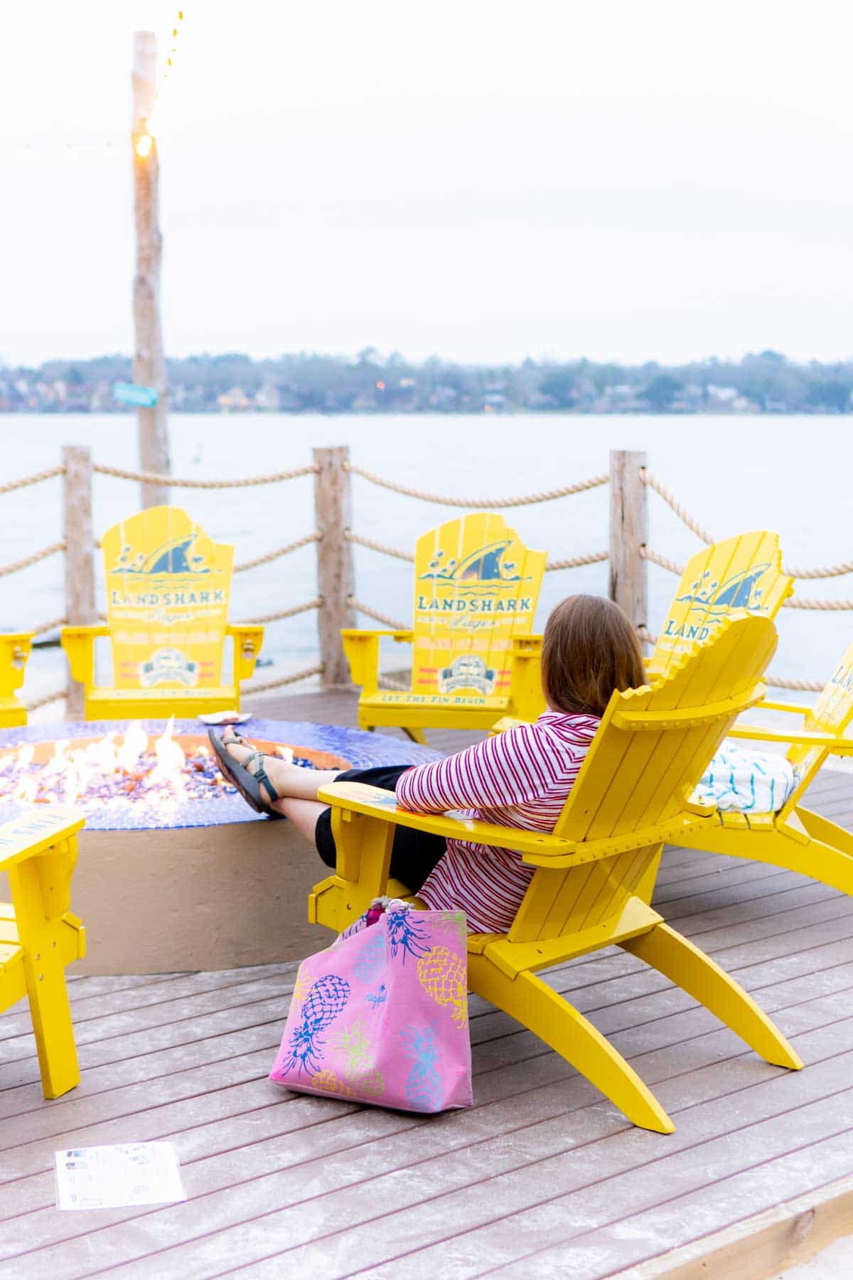 Woman sitting in a yellow chair next to Lake Conroe