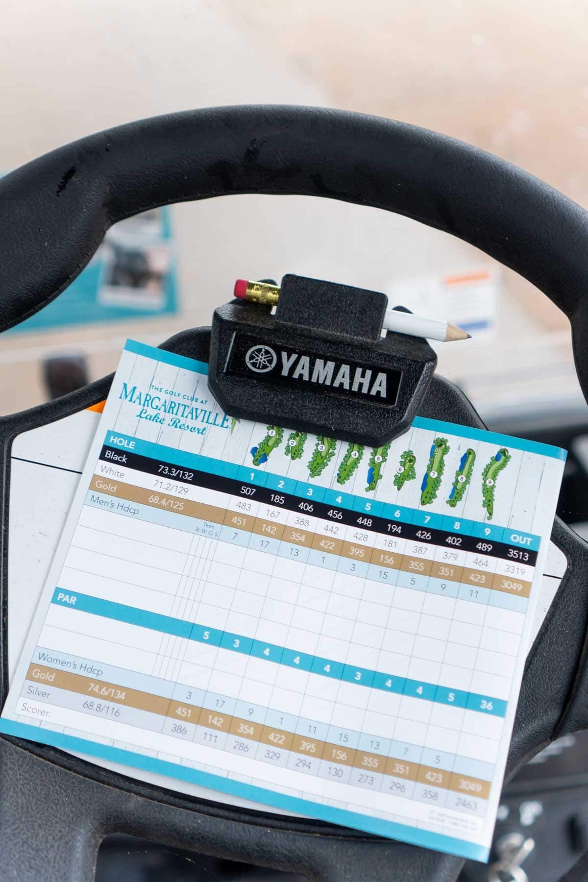 Golf scorecard on the steering wheel of a golf cart