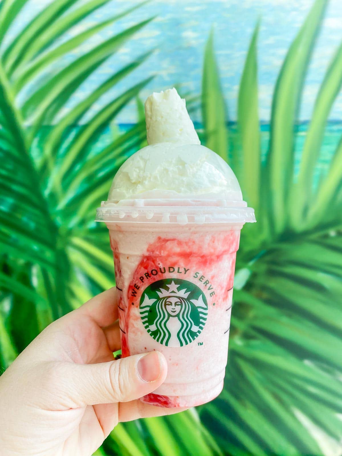 Woman's hand holding a Starbucks strawberries and creme