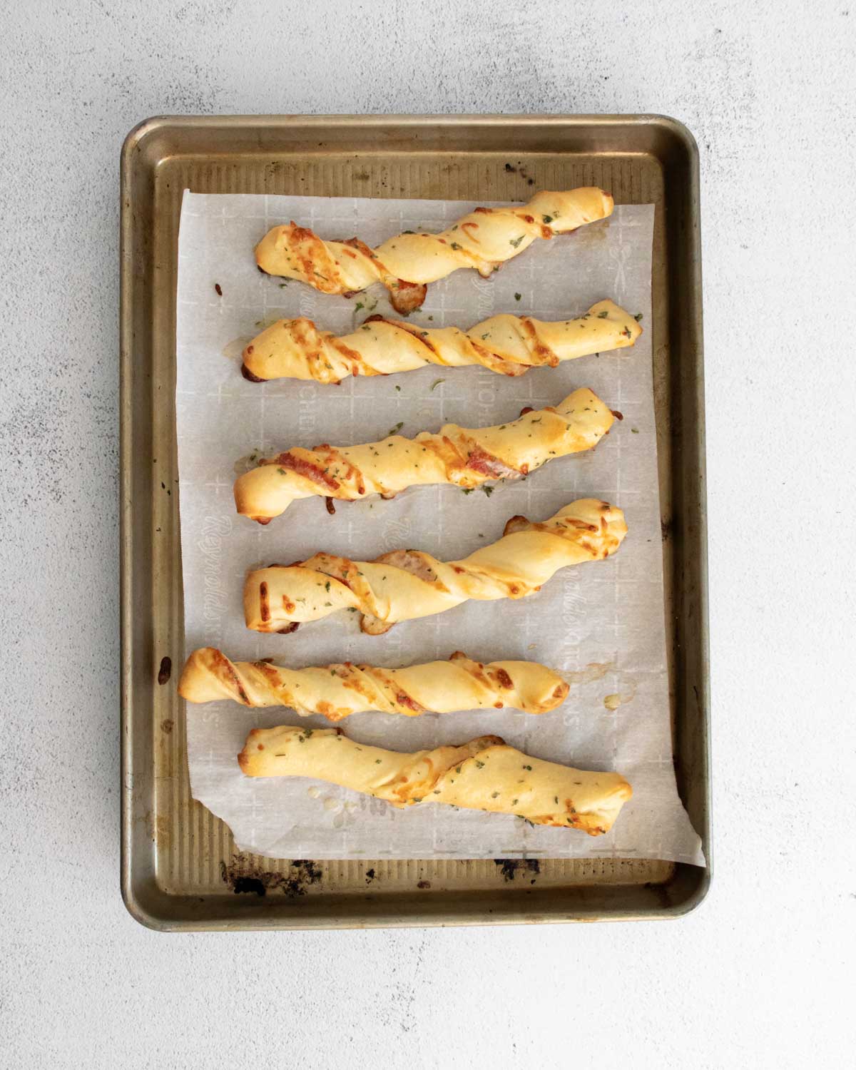 Baked pizza twists on a baking sheet