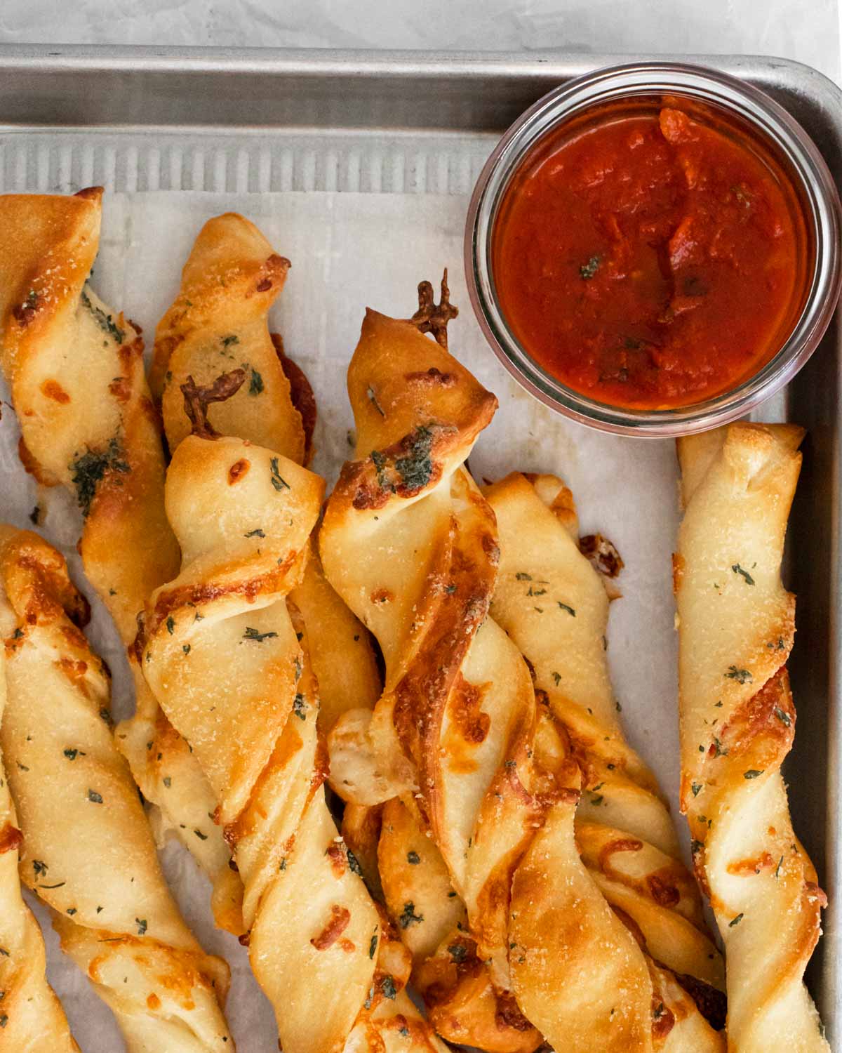 Close up plate of pizza twists with pizza sauce
