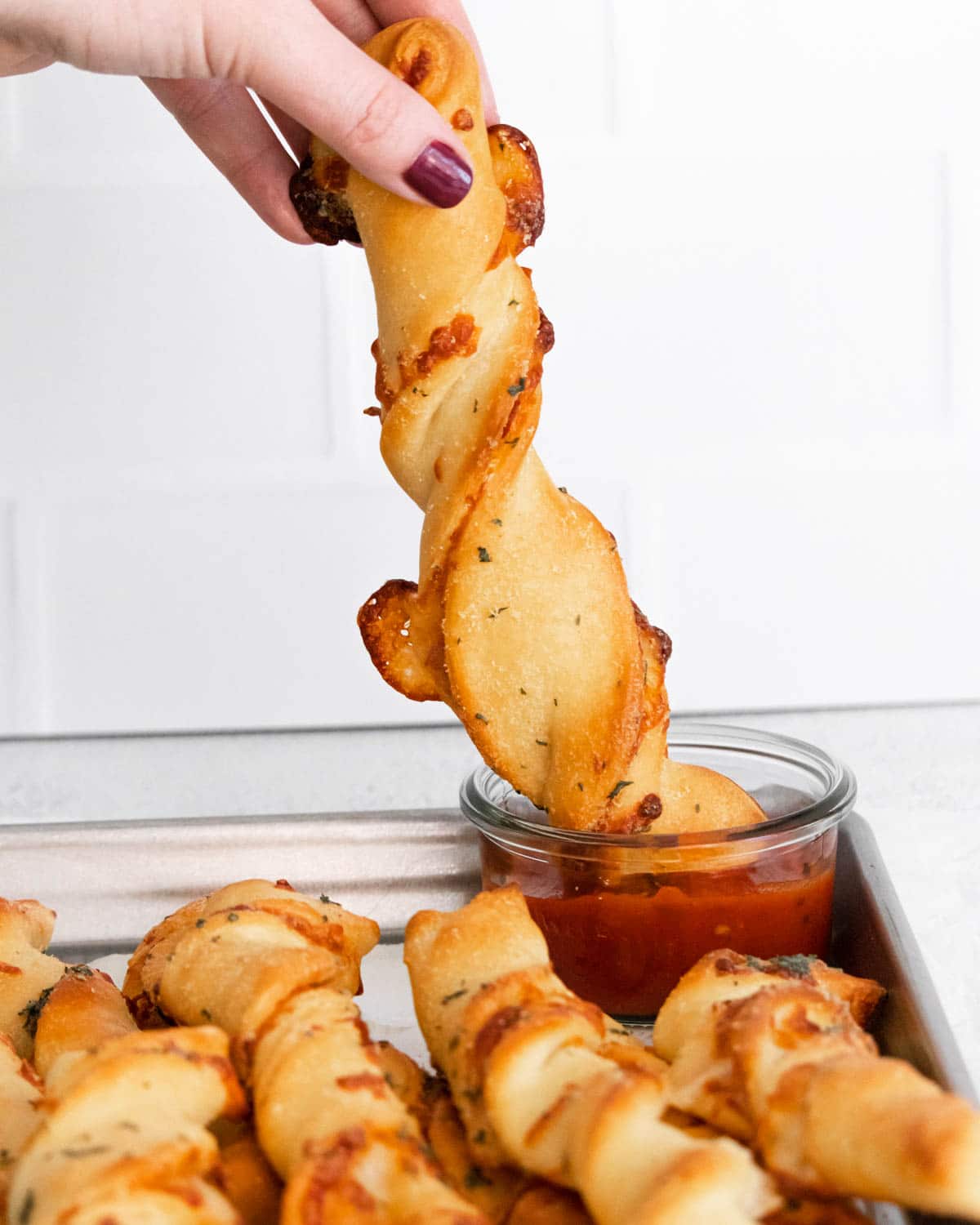 Pizza twists being dipped in sauce