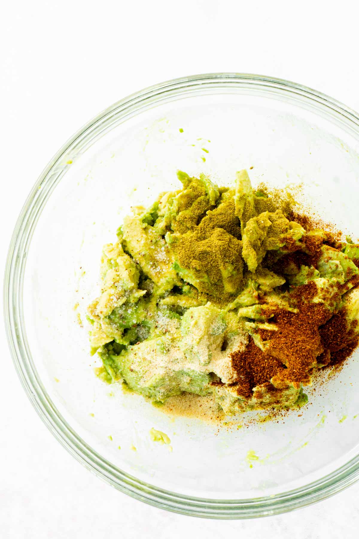 Avocado and spices in a glass bowl