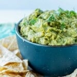 A blue bowl with guacamole in it