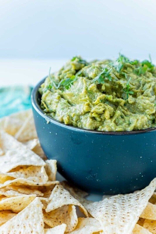 A blue bowl with guacamole in it