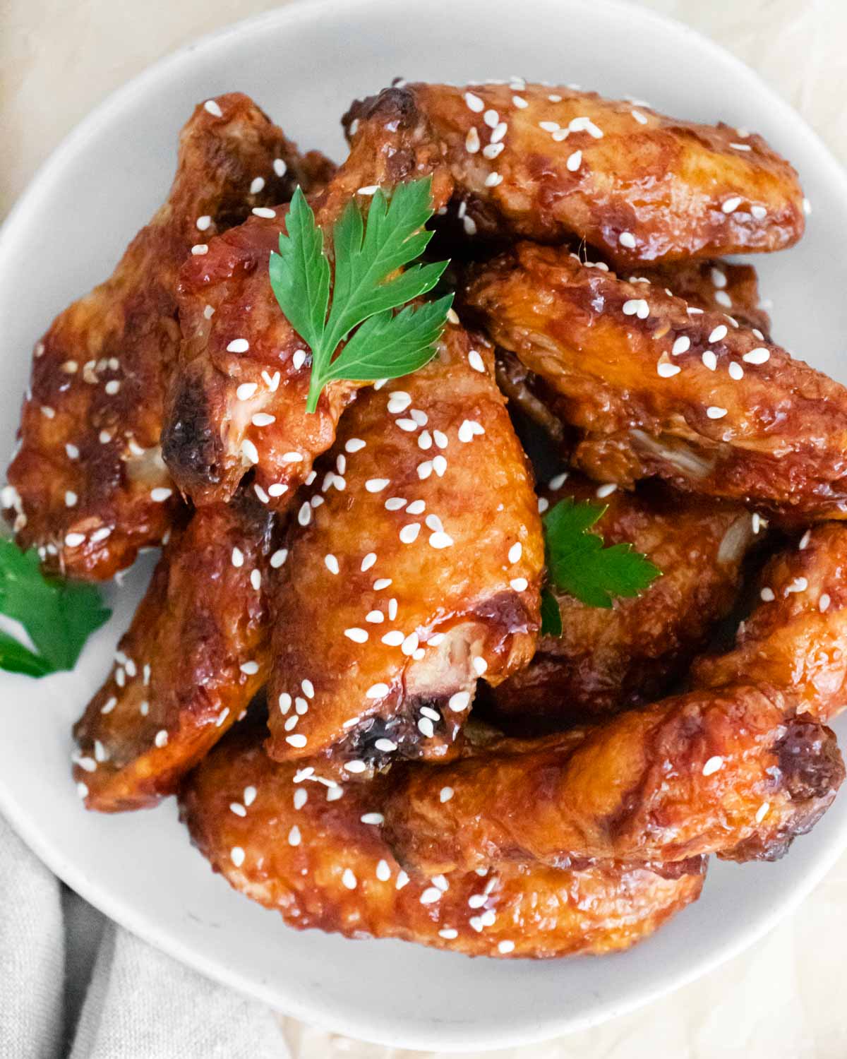 Bowl of sticky chicken wings with sesame seeds