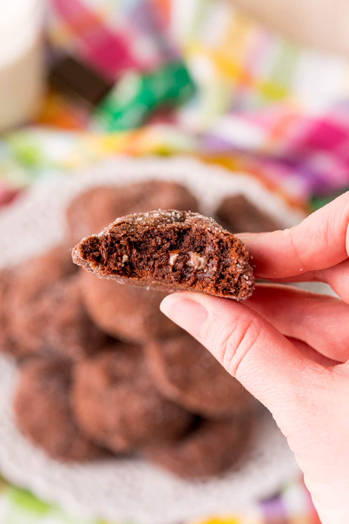 Woman's hand holding an Andes Mint cookie cut in half