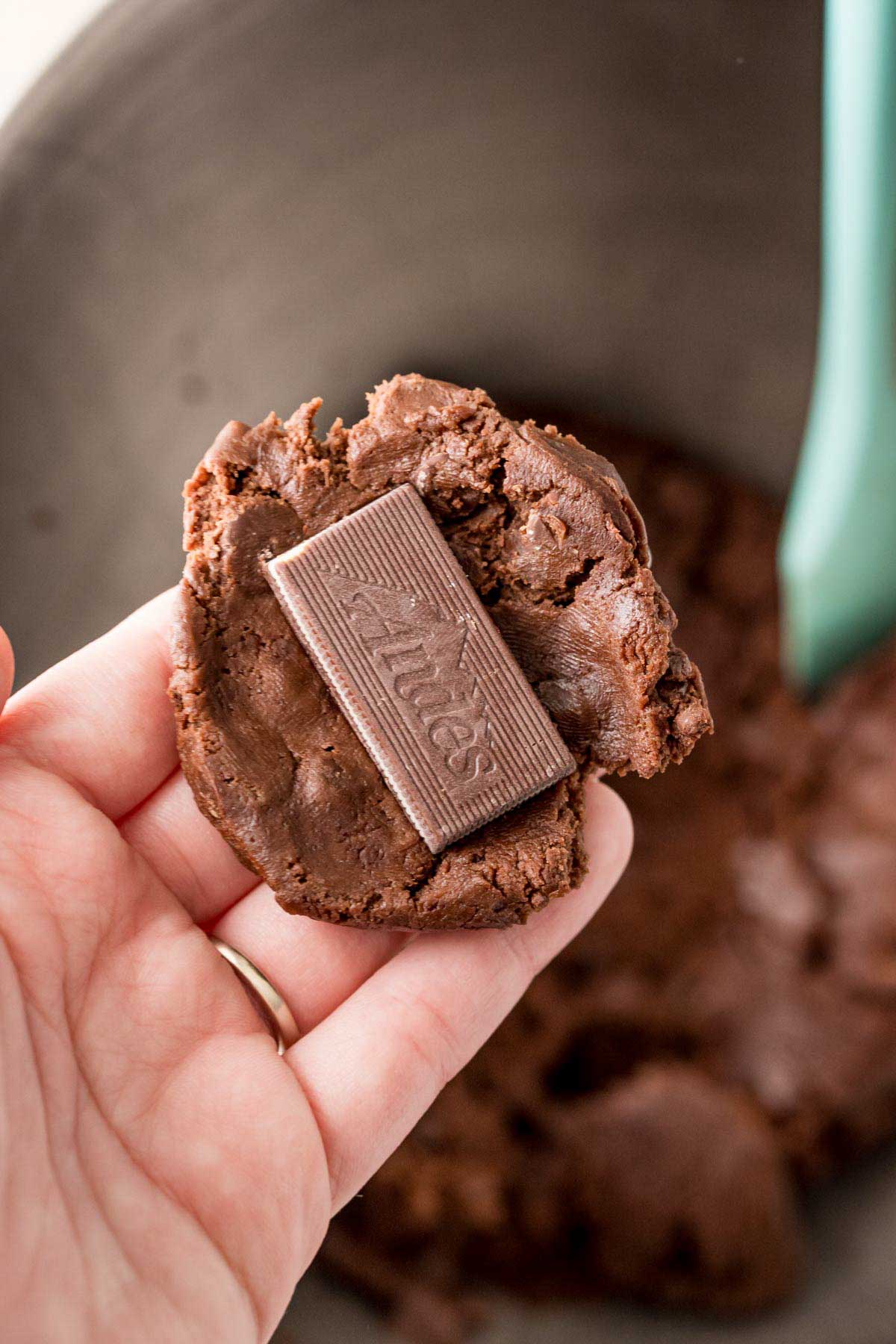 Hand holding an Andes mint cookie