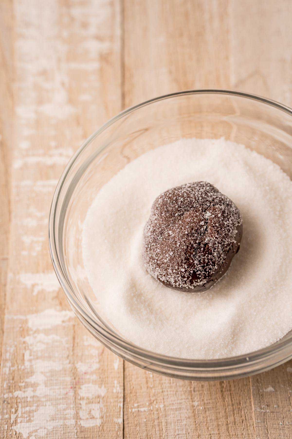 Andes mint cookie ball in a bowl of sugar