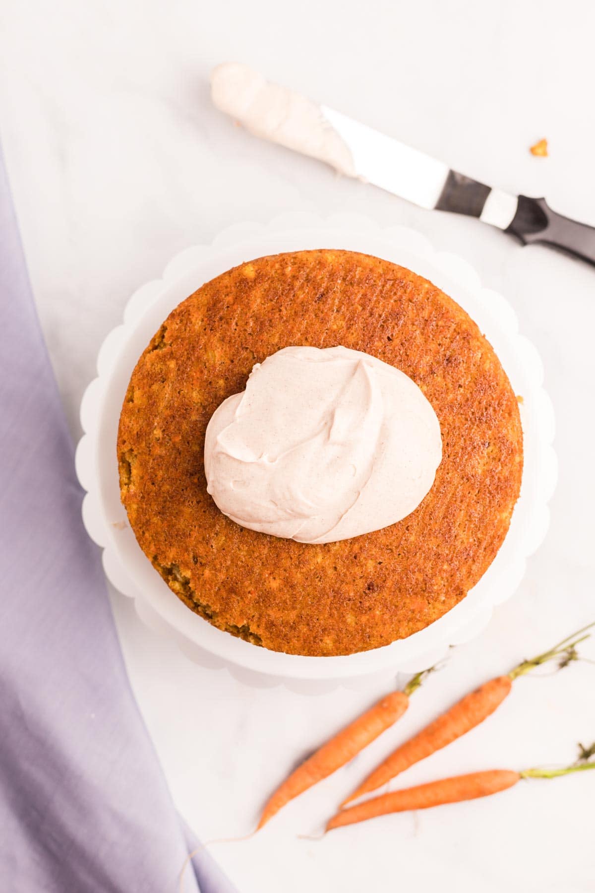 cream cheese frosting on top of a carrot cake