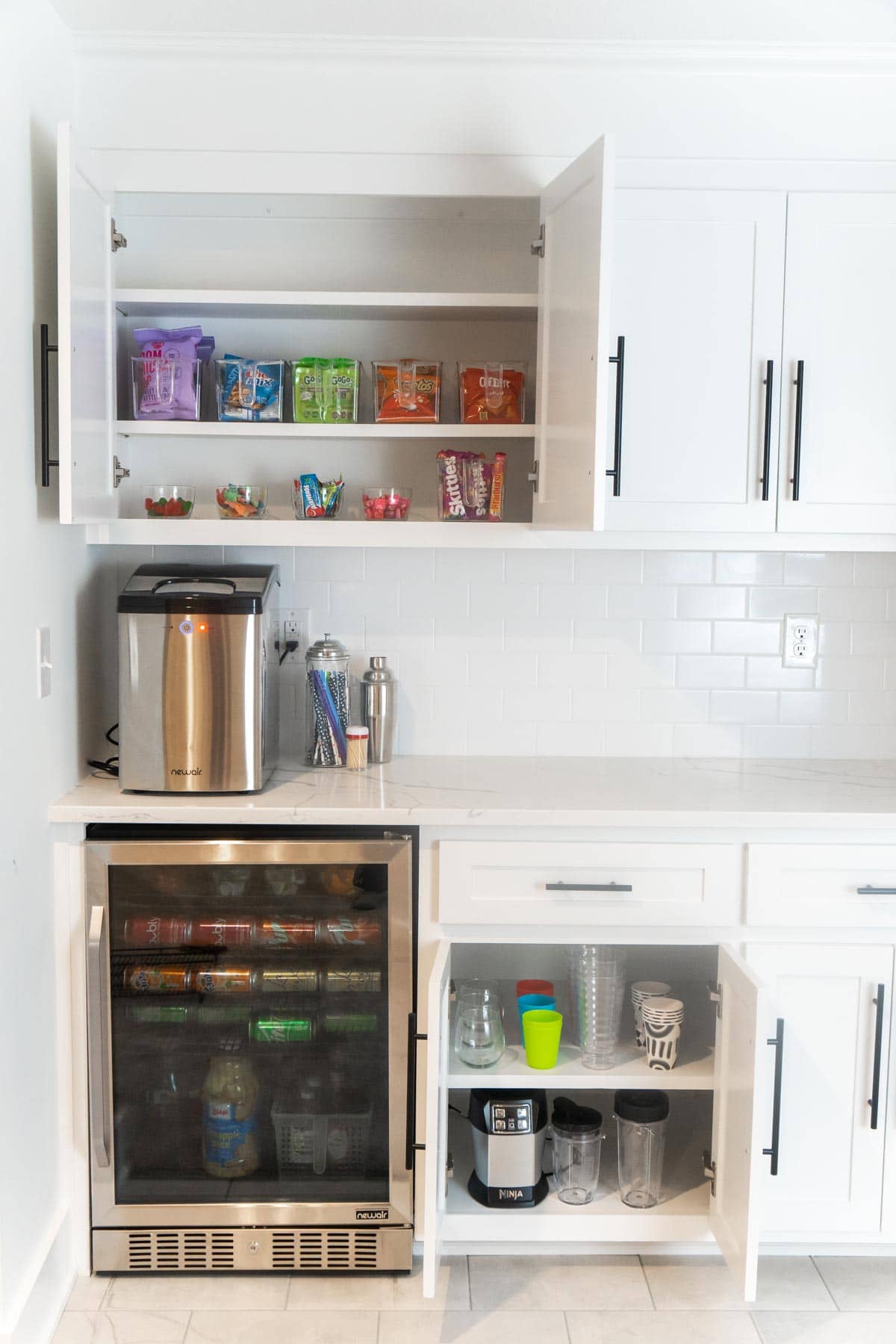 White dry bar with cabinets open