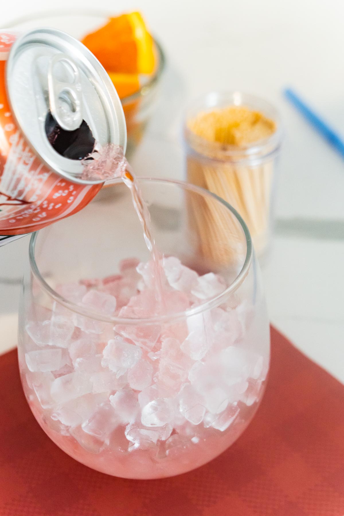 Cherry 7up being poured into a glass of nugget ice