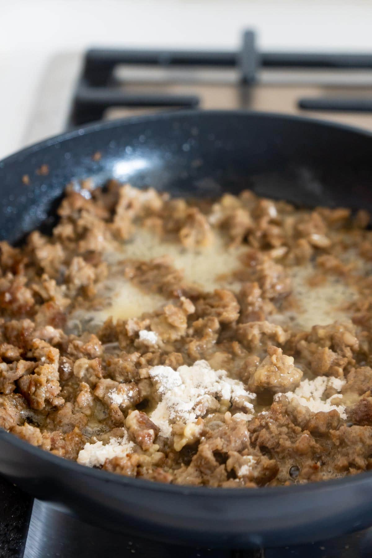 breakfast sausage in a pan with flour