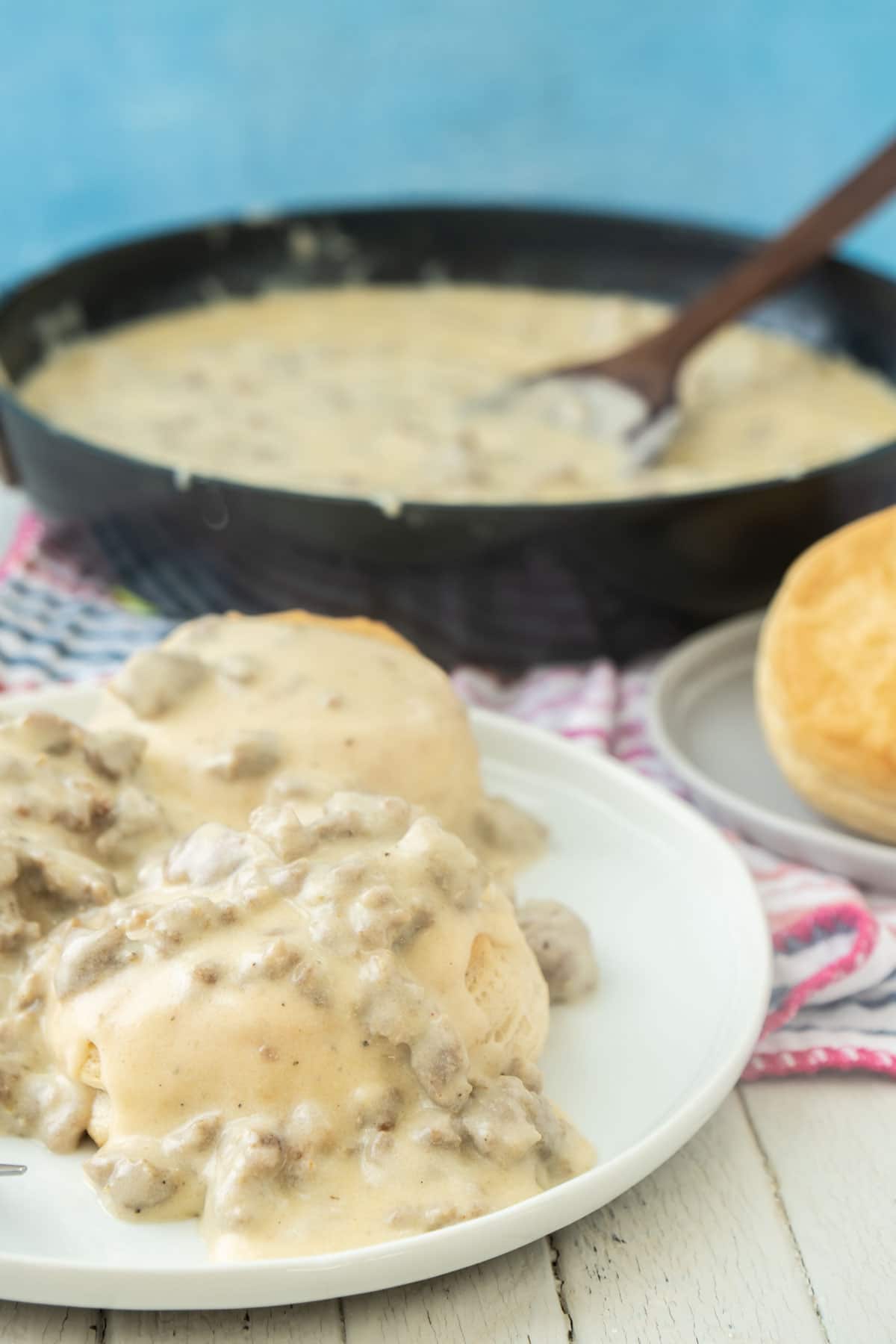 Biscuits and homemade sausage gravy on a white plate
