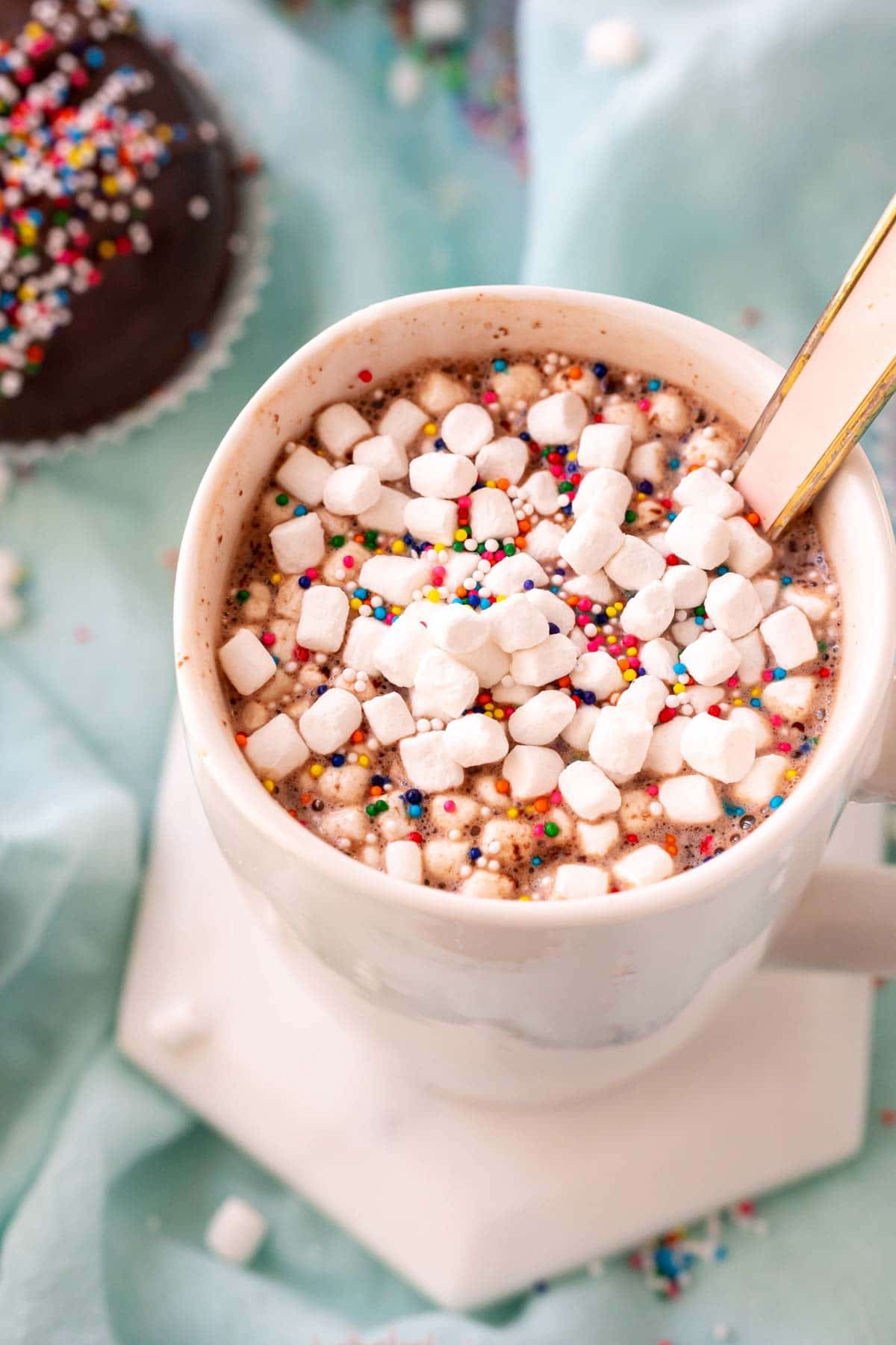 Glass of hot chocolate with marshmallows and sprinkles