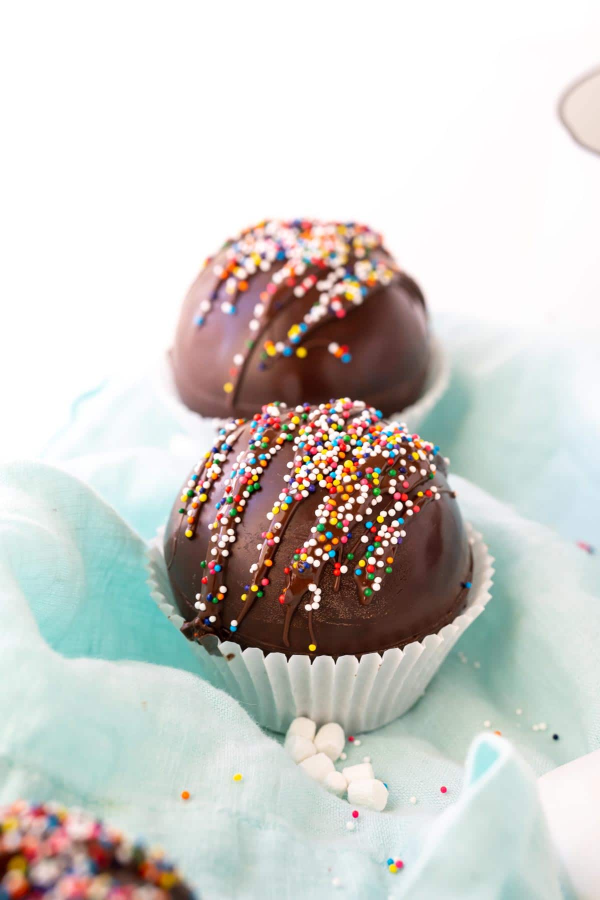 Two hot chocolate bombs with sprinkles