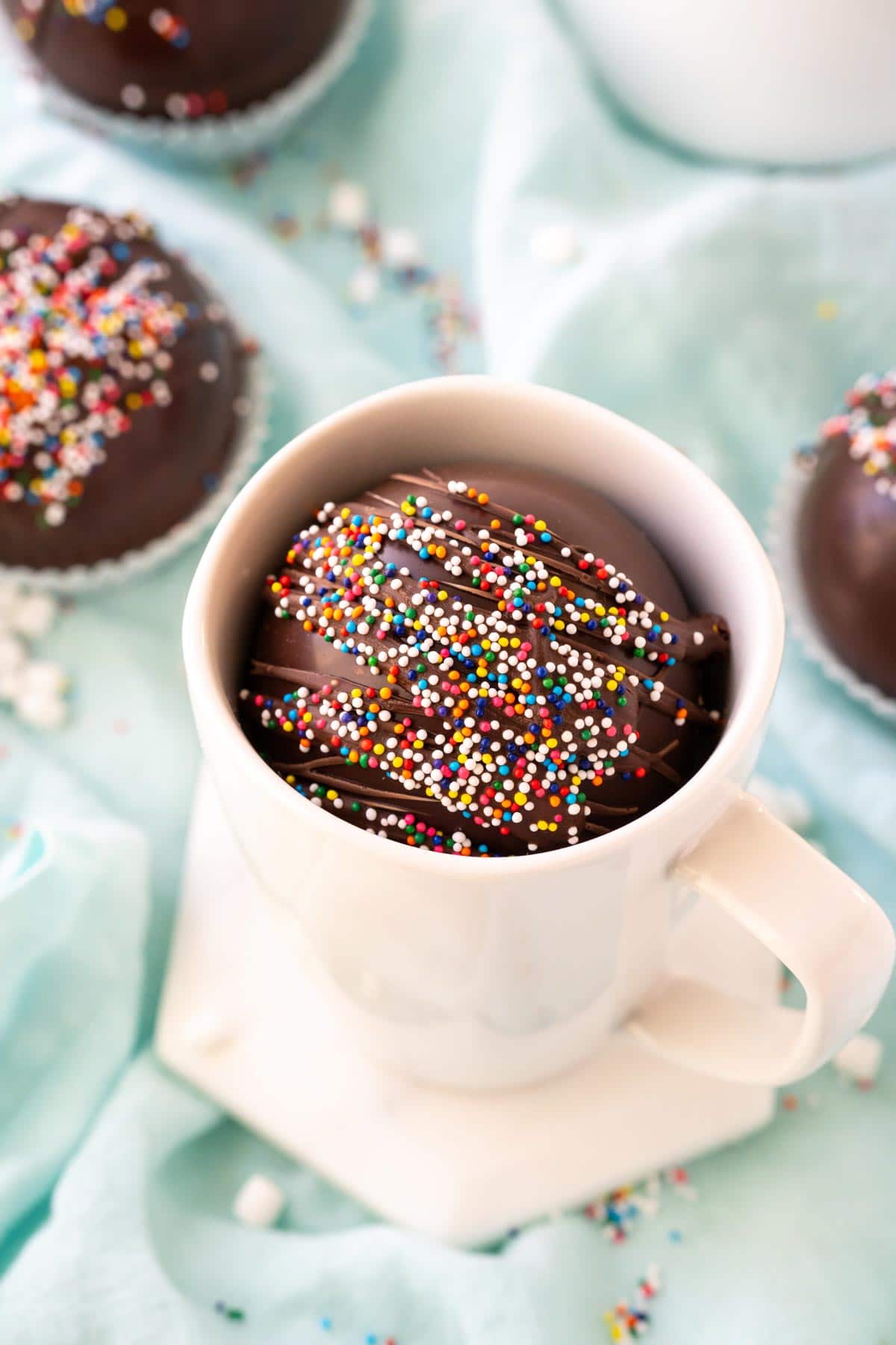Hot chocolate bomb with sprinkles in a mug