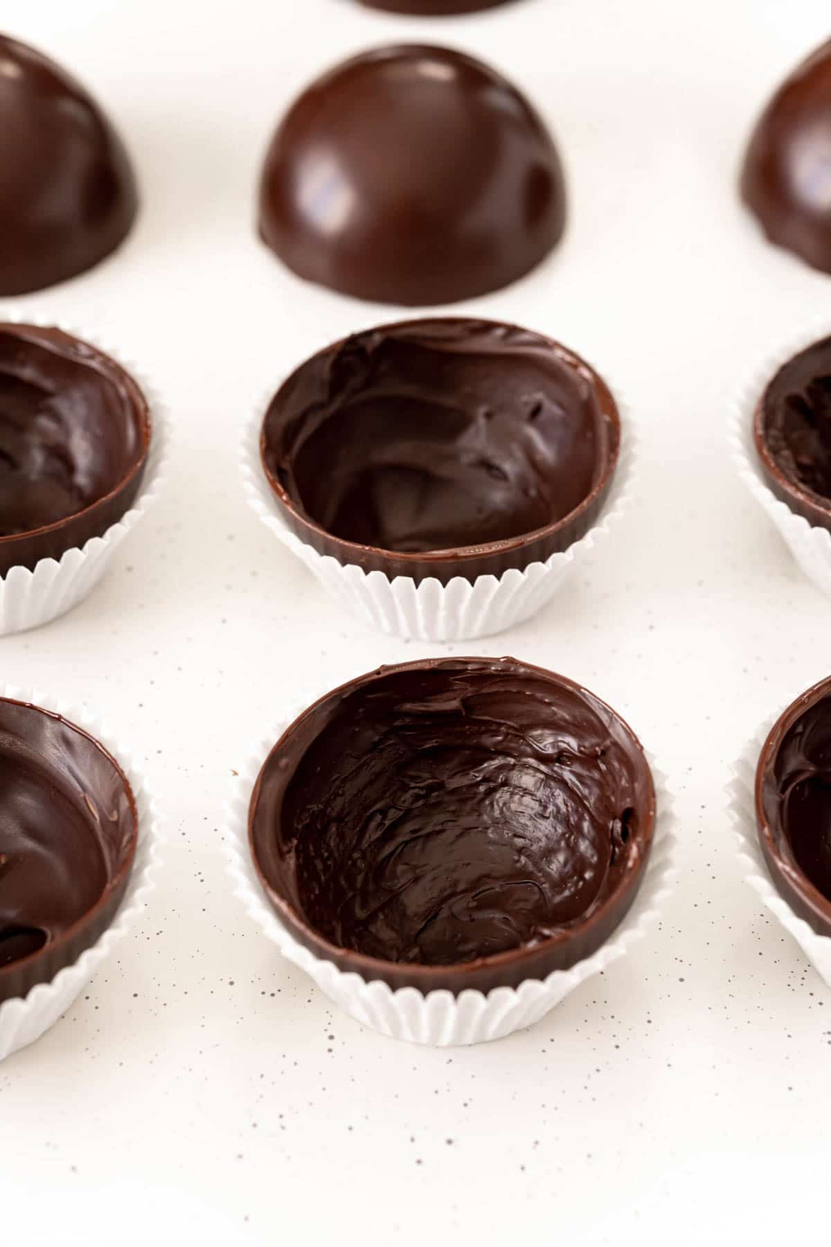 Hot chocolate bomb halves in white cupcake liners