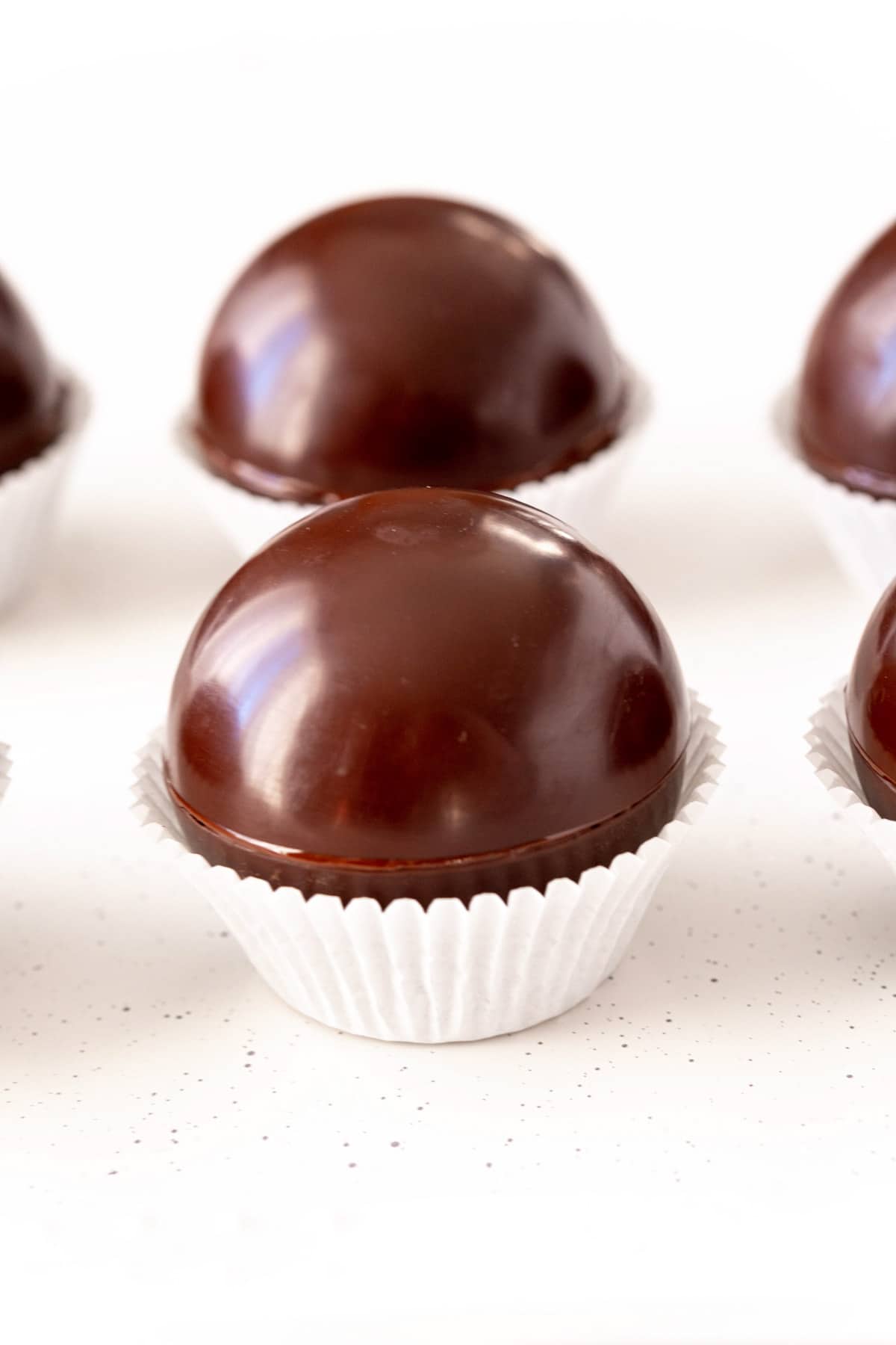 undecorated hot chocolate bombs in white cupcake liners