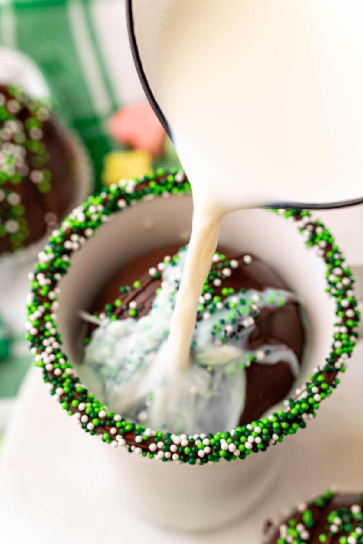 pouring milk over a hot chocolate bomb