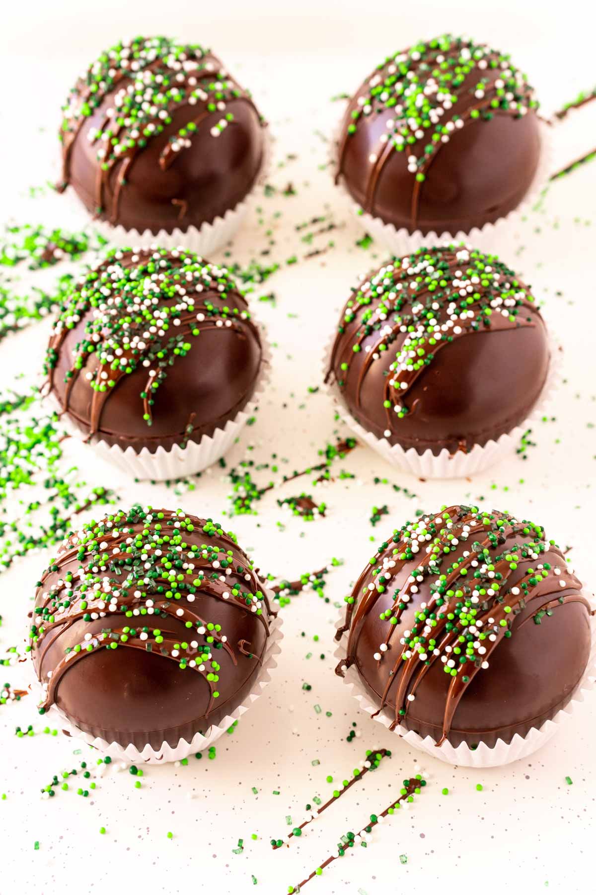 Mint hot chocolate bombs with green sprinkles on top