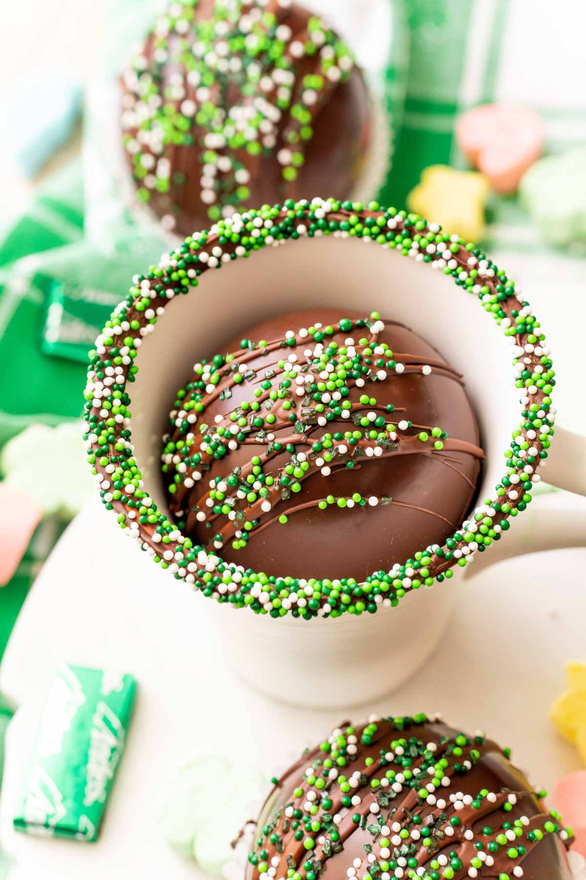 mint hot chocolate bombs in a mug