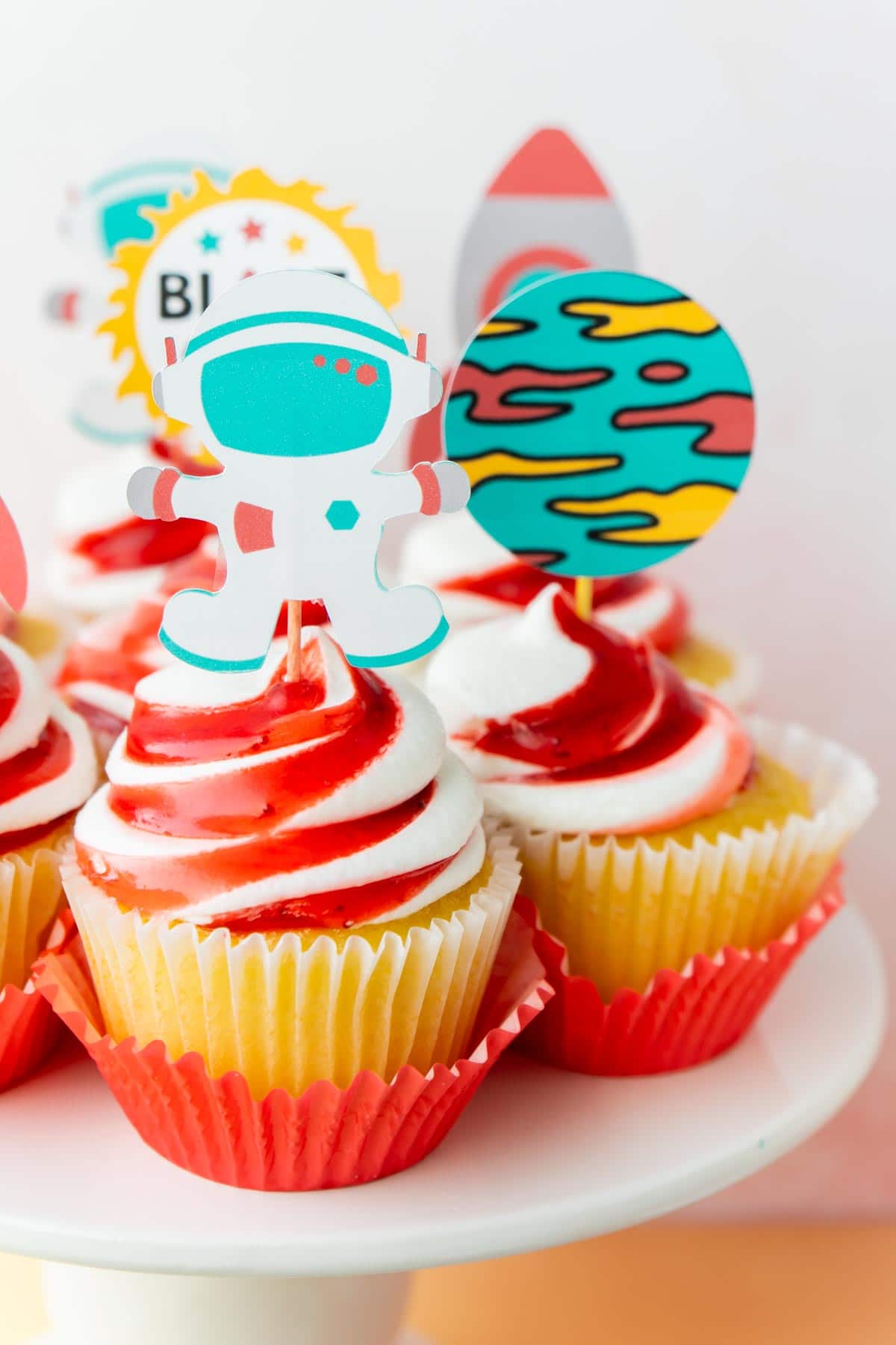 Cupcakes with red frosting and outer space cupcake toppers