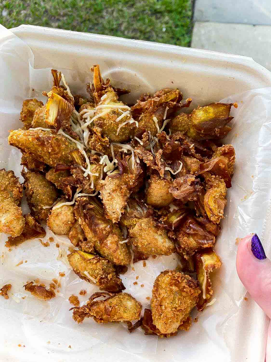 fried artichokes in a styrofoam container