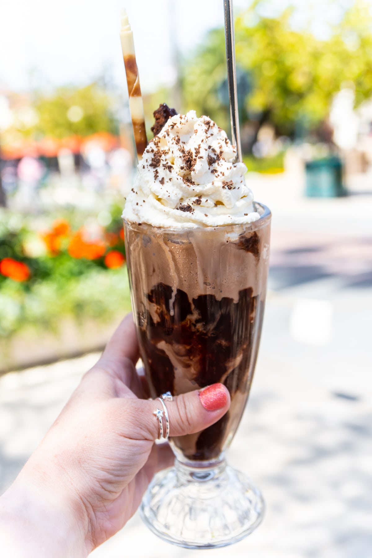 Double chocolate ice cream sundae being held by a hand