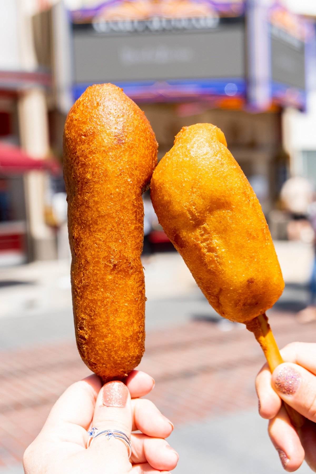 two corn dogs on sticks