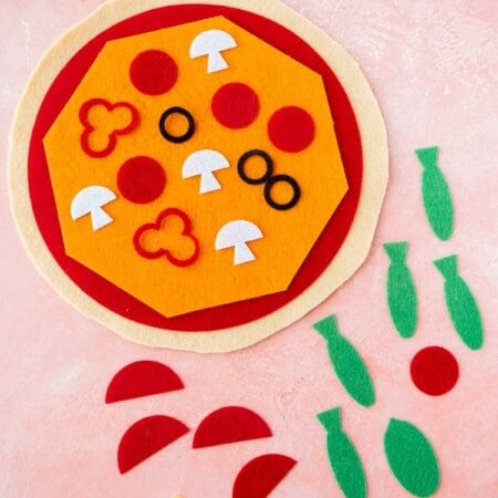 Felt pizza with toppings all around
