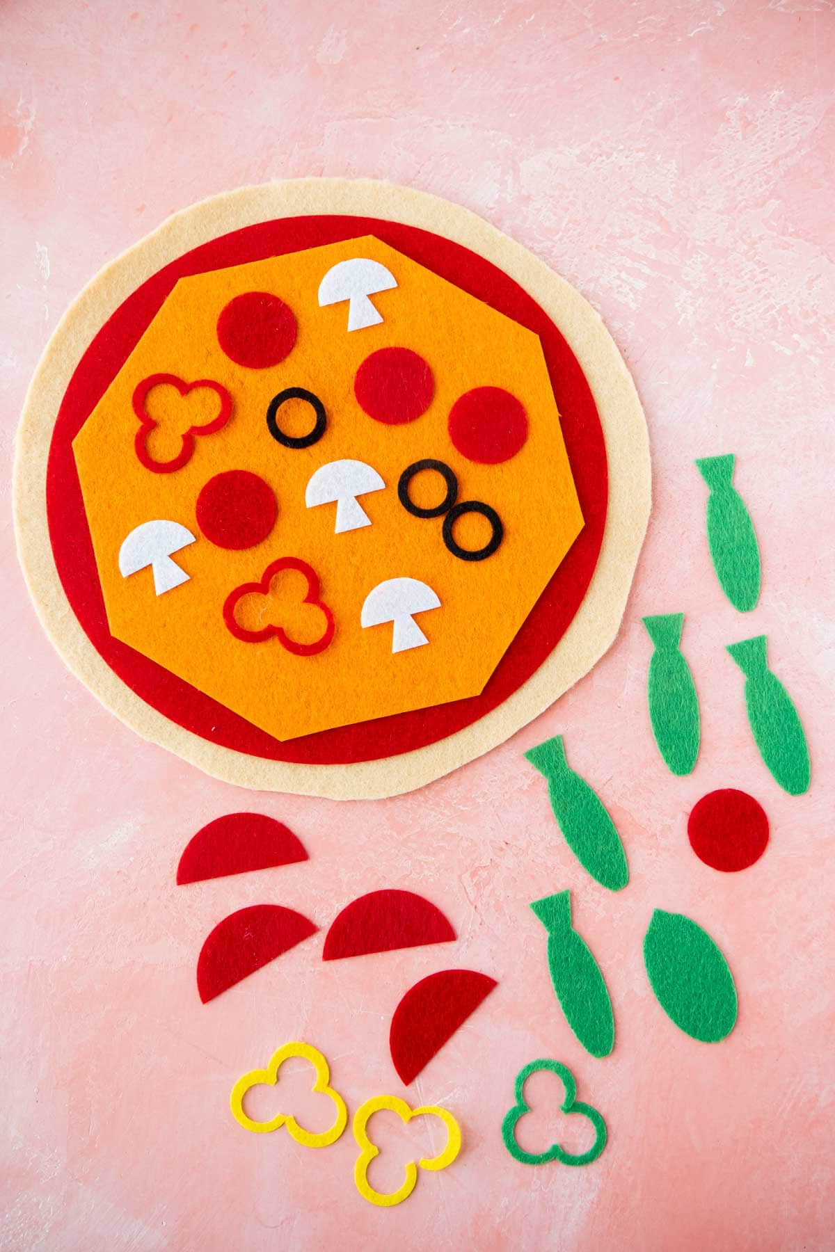 Felt pizza with toppings all around