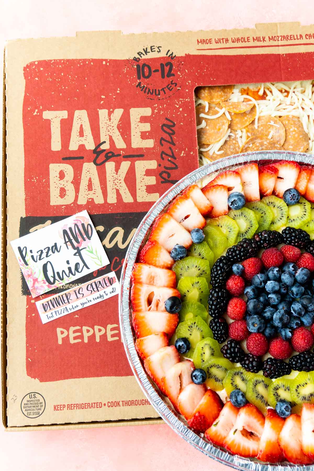 Pizza box with a fruit pizza on top