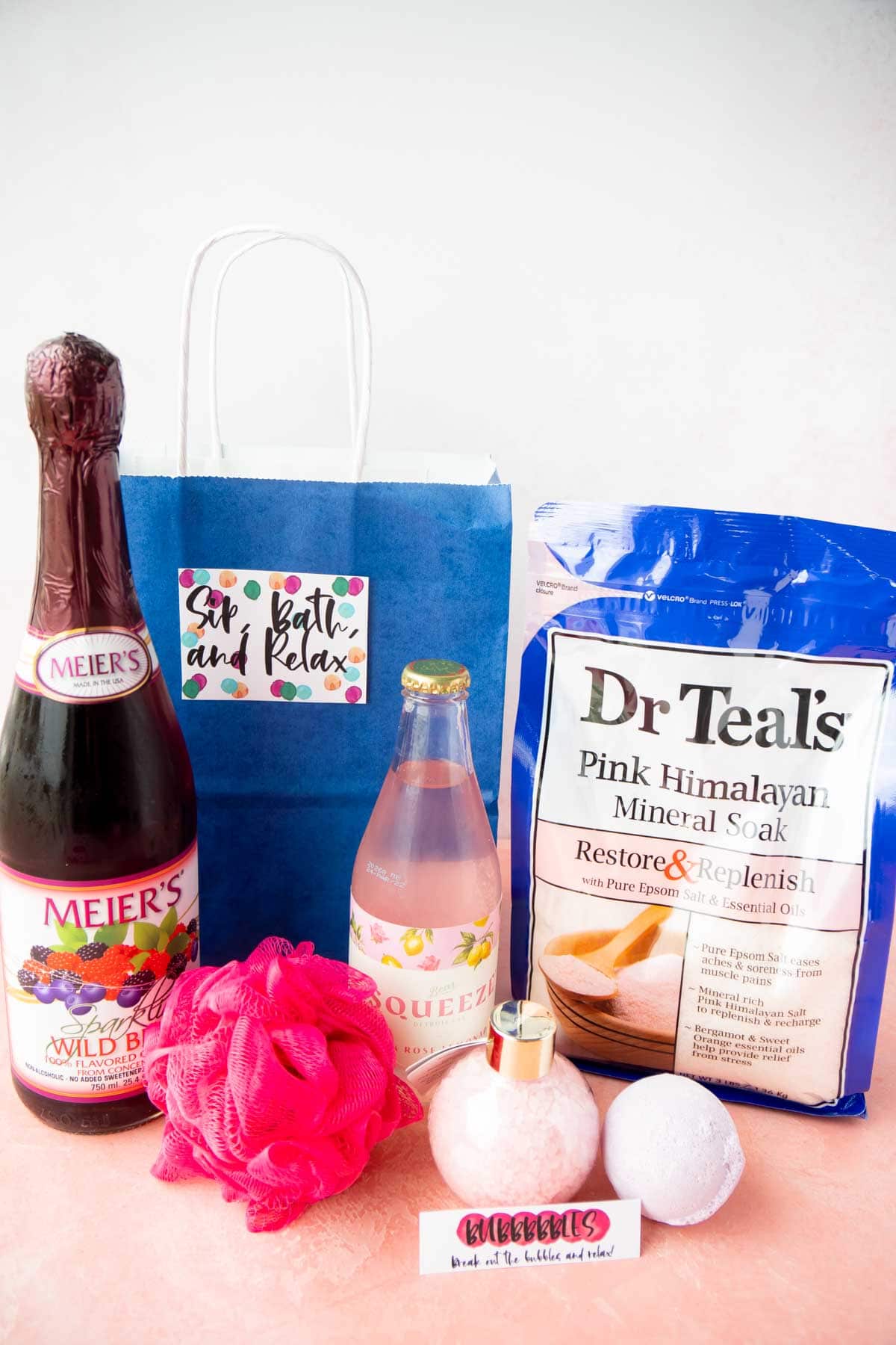 Blue gift basket with sparkling cider and bath salts