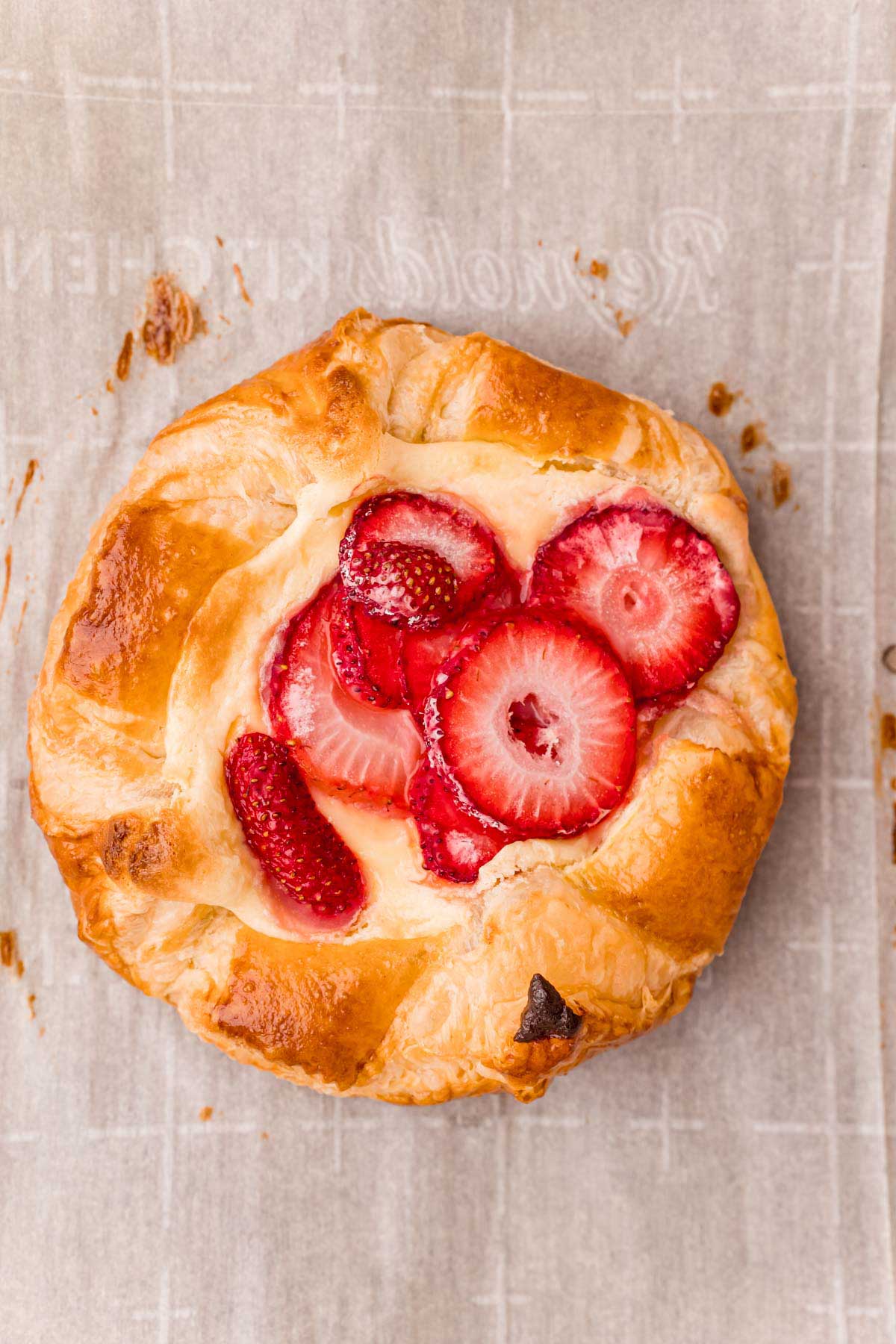 strawberry danish on a piece of parchment paper
