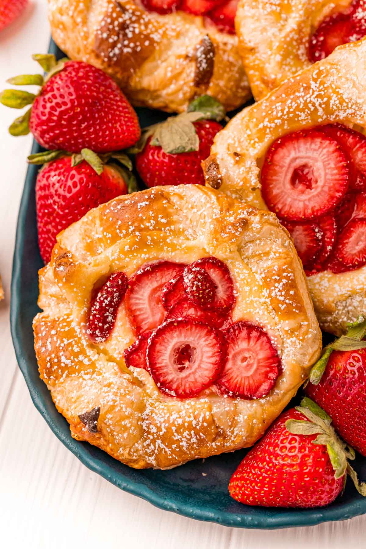 large strawberry danishes with strawberries all around