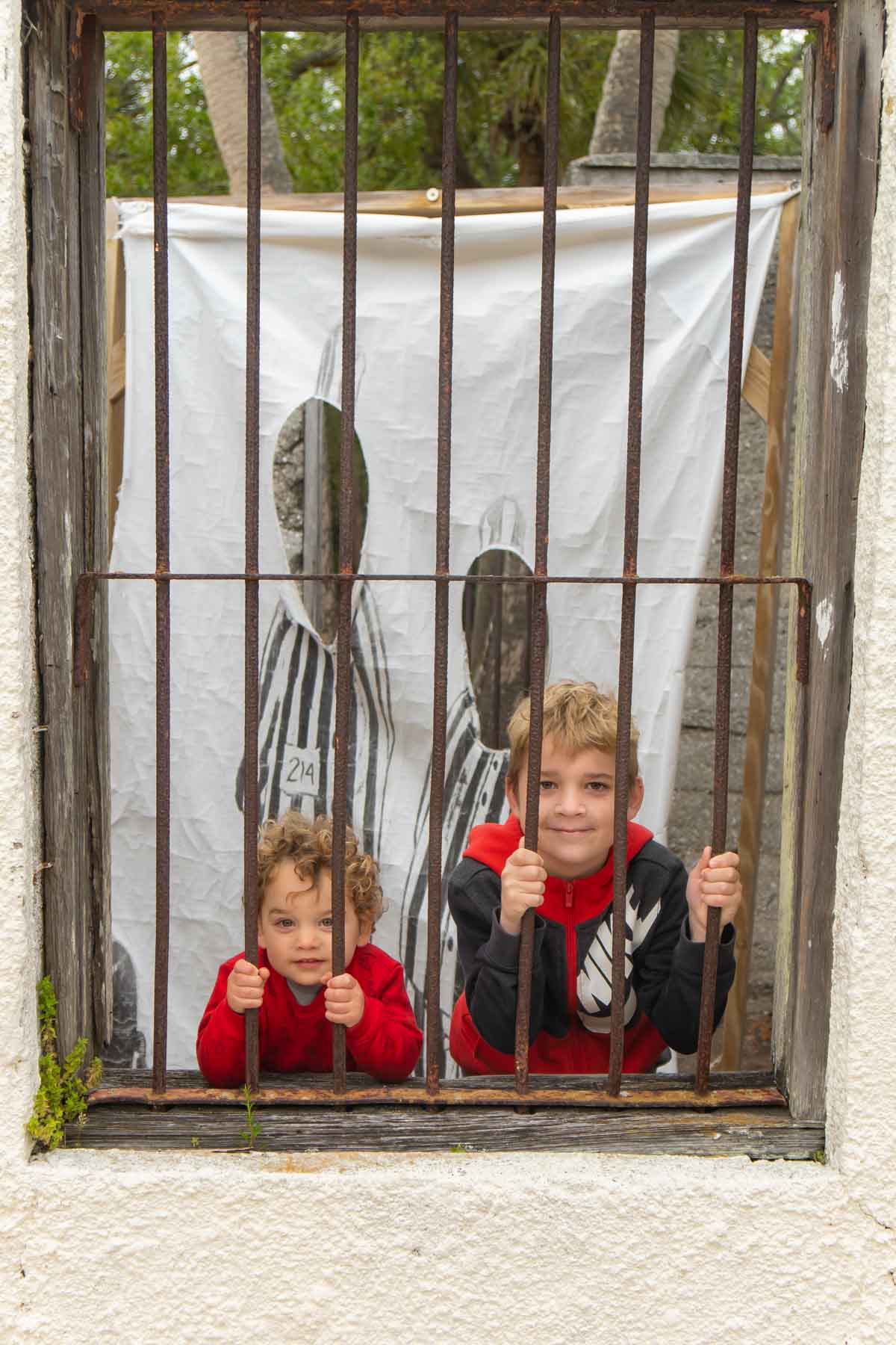 two boys behind bars