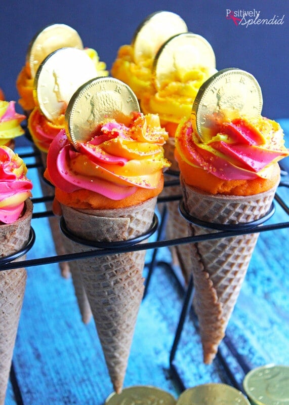 Cupcakes with orange frosting in cones