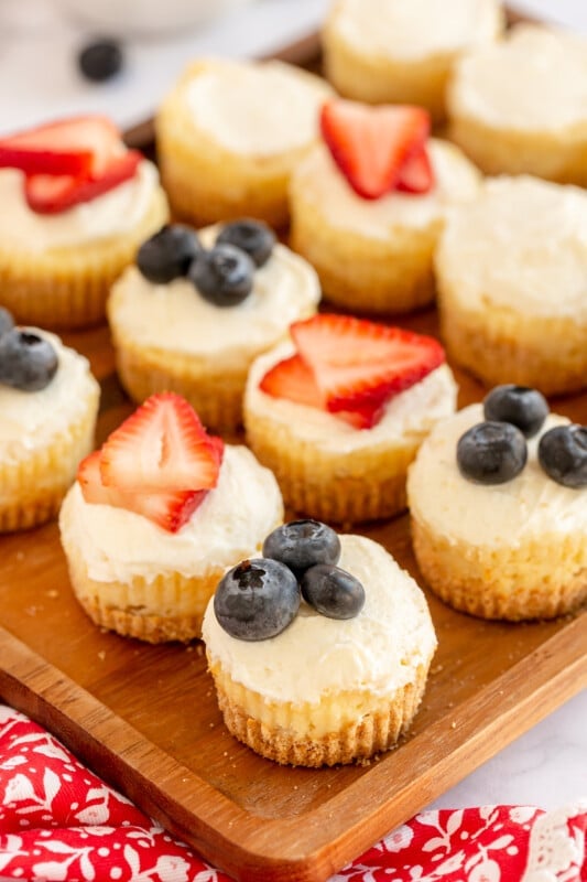 plate with fruit topped mini cheesecakes