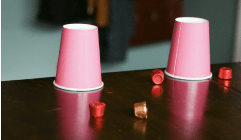 pink paper cups at the end of a table